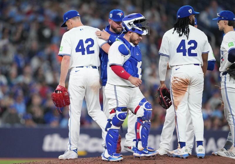 Apr 15, 2024; Toronto, Ontario, CAN;Toronto Blue Jays starting pitcher Chris Bassitt wearing number 42 for Jackie Robinson Day is relieved by manager John Schneider against the New York Yankees during the seventh inning at Rogers Centre. Mandatory Credit: Nick Turchiaro-USA TODAY Sports