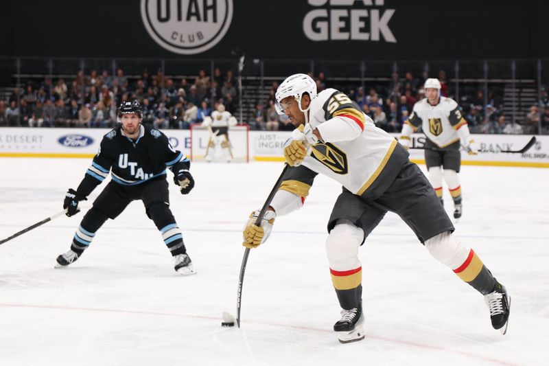 Nov 15, 2024; Salt Lake City, Utah, USA; Vegas Golden Knights right wing Keegan Kolesar (55) takes a shot against the Utah Hockey Club during the first period at Delta Center. Mandatory Credit: Rob Gray-Imagn Images