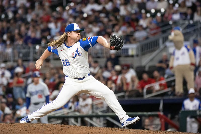 Sep 14, 2024; Cumberland, Georgia, USA; Atlanta Braves pitcher Grant Holmes (66) pitches the ball against the Los Angeles Dodgers during the seventh inning at Truist Park. Mandatory Credit: Jordan Godfree-Imagn Images