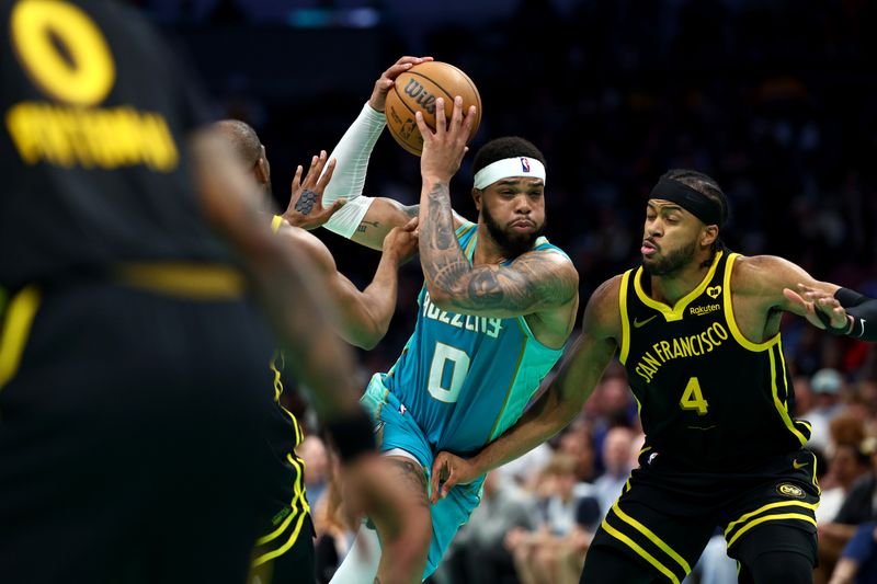 CHARLOTTE, NORTH CAROLINA - MARCH 29: Miles Bridges #0 of the Charlotte Hornets drives to the basket against Moses Moody #4 of the Golden State Warriors during the second half of the game at Spectrum Center on March 29, 2024 in Charlotte, North Carolina. NOTE TO USER: User expressly acknowledges and agrees that, by downloading and or using this photograph, User is consenting to the terms and conditions of the Getty Images License Agreement. (Photo by Jared C. Tilton/Getty Images)