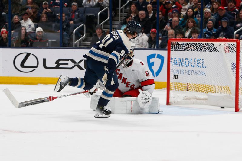 Dec 31, 2024; Columbus, Ohio, USA; Columbus Blue Jackets center Kent Johnson (91) scores a goal against the Carolina Hurricanes during the shootout at Nationwide Arena. Mandatory Credit: Russell LaBounty-Imagn Images