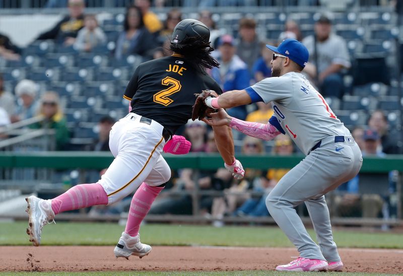 May 12, 2024; Pittsburgh, Pennsylvania, USA;  Chicago Cubs second baseman Nick Madrigal (1) tags Pittsburgh Pirates right fielder Connor Joe (2) out on a caught stealing run down between first and second bases during the fourth inning at PNC Park. Mandatory Credit: Charles LeClaire-USA TODAY Sports