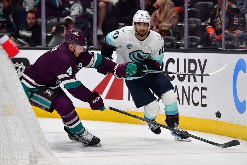 Apr 5, 2024; Anaheim, California, USA; Anaheim Ducks defenseman Cam Fowler (4) plays for the puck against Seattle Kraken center Matty Beniers (10) during the third period at Honda Center. Mandatory Credit: Gary A. Vasquez-USA TODAY Sports