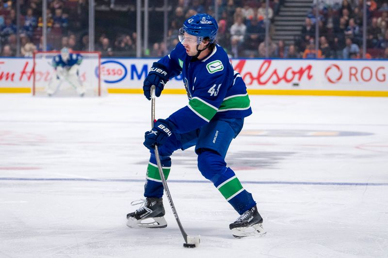 Oct 4, 2024; Vancouver, British Columbia, CAN; Vancouver Canucks defenseman Quinn Hughes (43) makes a pass against the Edmonton Oilers during the third period at Rogers Arena. Mandatory Credit: Bob Frid-Imagn Images