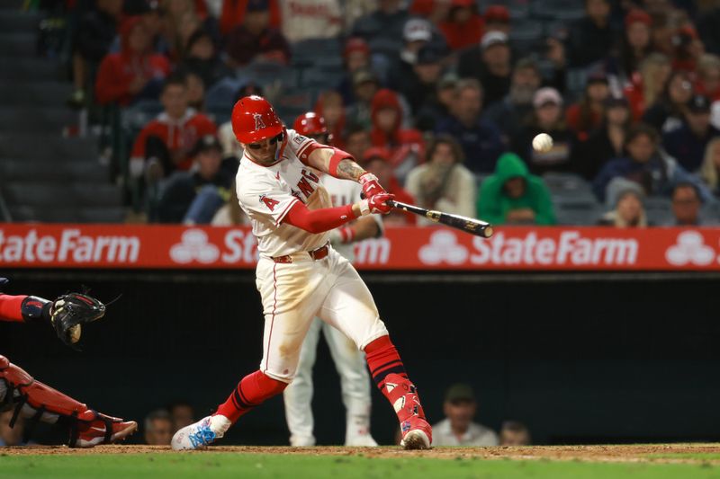 Apr 26, 2024; Anaheim, California, USA;  Los Angeles Angels shortstop Zach Neto (9) hits an RBI single during the ninth inning against the Minnesota Twins at Angel Stadium. Mandatory Credit: Kiyoshi Mio-USA TODAY Sports