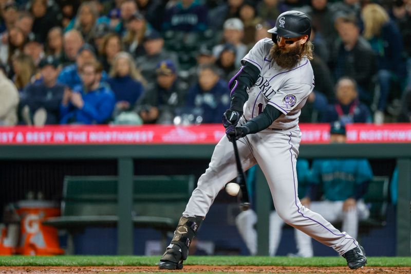 Apr 14, 2023; Seattle, Washington, USA; Colorado Rockies designated hitter Charlie Blackmon (19) hits a single against the Seattle Mariners during the sixth inning at T-Mobile Park. Mandatory Credit: Joe Nicholson-USA TODAY Sports