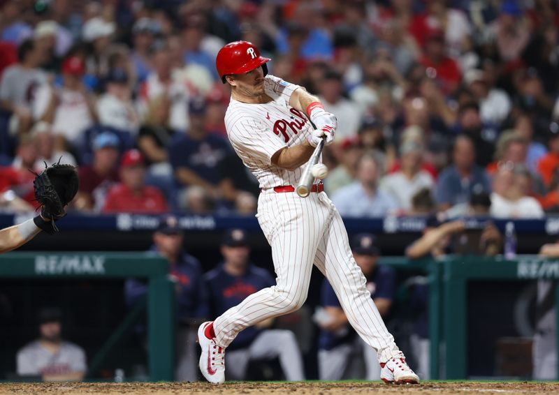 Aug 27, 2024; Philadelphia, Pennsylvania, USA; Philadelphia Phillies catcher J.T. Realmuto (10) hits a double during the sixth inning against the Houston Astros during the sixth inning at Citizens Bank Park. Mandatory Credit: Bill Streicher-USA TODAY Sports