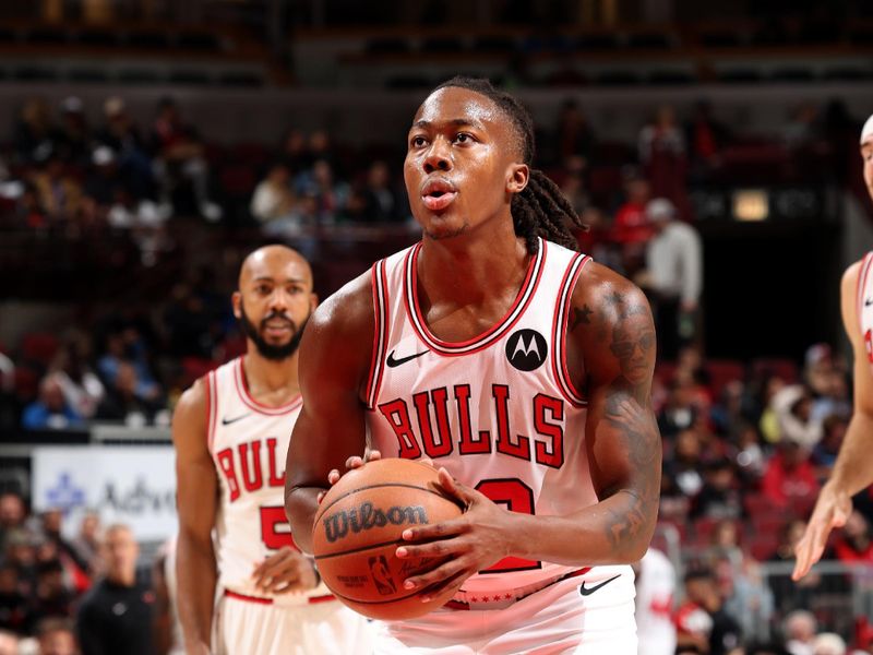 CHICAGO, IL - OCTOBER 19: Ayo Dosunmu #12 of the Chicago Bulls prepares to shoot a free throw during the game against the Minnesota Timberwolves on October 19, 2023 at United Center in Chicago, Illinois. NOTE TO USER: User expressly acknowledges and agrees that, by downloading and or using this photograph, User is consenting to the terms and conditions of the Getty Images License Agreement. Mandatory Copyright Notice: Copyright 2023 NBAE (Photo by Jeff Haynes/NBAE via Getty Images)