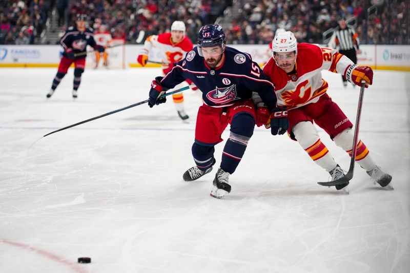 Nov 29, 2024; Columbus, Ohio, USA;  Columbus Blue Jackets defenseman Dante Fabbro (15) skates against Calgary Flames right wing Matt Coronato (27) in the third period at Nationwide Arena. Mandatory Credit: Aaron Doster-Imagn Images