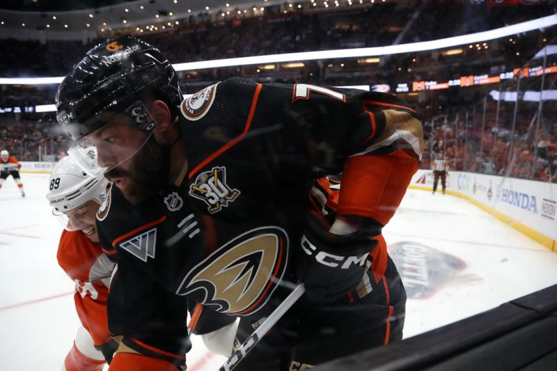 Nov 10, 2023; Anaheim, California, USA; Philadelphia Flyers right wing Cam Atkinson (89) checks Anaheim Ducks defenseman Radko Gudas (7) during the third period at Honda Center. Mandatory Credit: Kiyoshi Mio-USA TODAY Sports