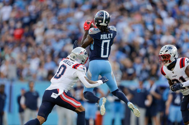 Tennessee Titans wide receiver Calvin Ridley (0) catches a pass as New England Patriots cornerback Christian Gonzalez (0) defends during overtime of an NFL football game, Sunday, Nov. 3, 2024, in Nashville, Tenn. (AP Photo/Stew Milne)