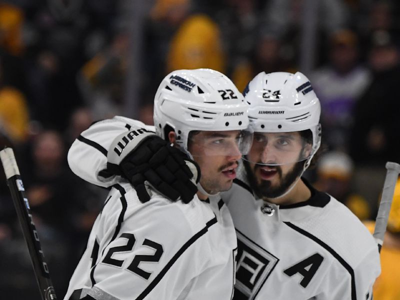 Jan 31, 2024; Nashville, Tennessee, USA; Los Angeles Kings left wing Kevin Fiala (22) and center Phillip Danault (24) celebrate after an empty net goal during the third period against the Nashville Predators at Bridgestone Arena. Mandatory Credit: Christopher Hanewinckel-USA TODAY Sports