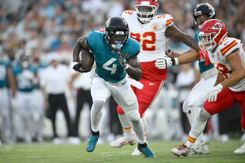 Jacksonville Jaguars running back Tank Bigsby (4) runs with the ball during the first half of an NFL preseason football game against the Kansas City Chiefs Saturday, Aug. 10, 2024, in Jacksonville, Fla. (AP Photo/Phelan M. Ebenhack)