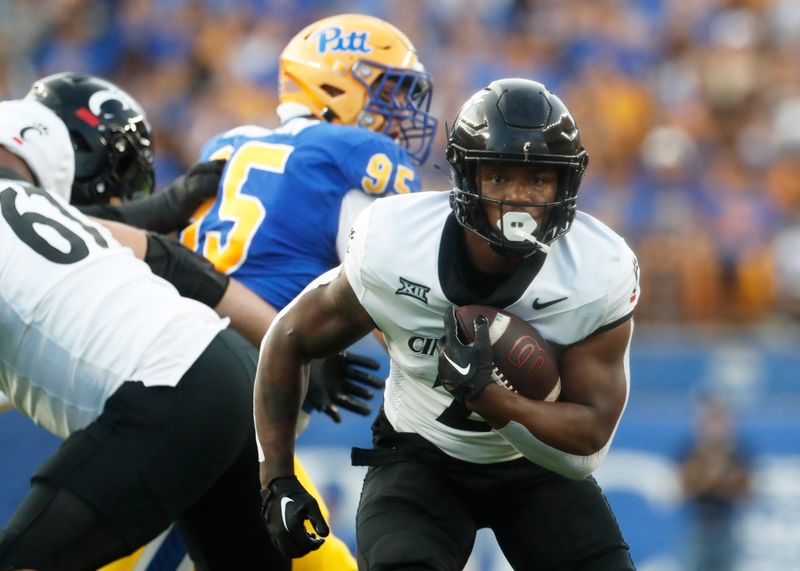 Sep 9, 2023; Pittsburgh, Pennsylvania, USA; Cincinnati Bearcats running back Corey Kiner (21)carries the ball against the Pittsburgh Panthers during the first quarter at Acrisure Stadium. Mandatory Credit: Charles LeClaire-USA TODAY Sports