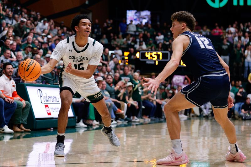 Mar 1, 2025; Fort Collins, Colorado, USA; Colorado State Rams guard Jalen Lake (15) passes the ball as Utah State Aggies guard Mason Falslev (12) guards in the first half at Moby Arena. Mandatory Credit: Isaiah J. Downing-Imagn Images