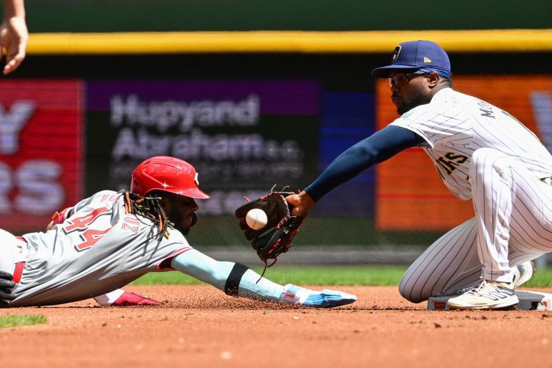 Aug 11, 2024; Milwaukee, Wisconsin, USA; Cincinnati Reds shortstop Elly De La Cruz (44) gets back to second base before the tag by Milwaukee Brewers second baseman Andruw Monasterio (14) on a pickoff attempt in the first inning at American Family Field. Mandatory Credit: Benny Sieu-USA TODAY Sports