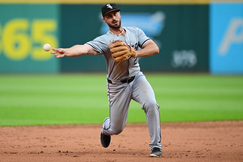 Jul 2, 2024; Cleveland, Ohio, USA; Chicago White Sox shortstop Paul DeJong (29) attempts to throw out Cleveland Guardians first baseman Josh Naylor (not pictured) at third base during the sixth inning at Progressive Field. DeJong hit Naylor with the ball and Naylor scored on the play. Mandatory Credit: Ken Blaze-USA TODAY Sports