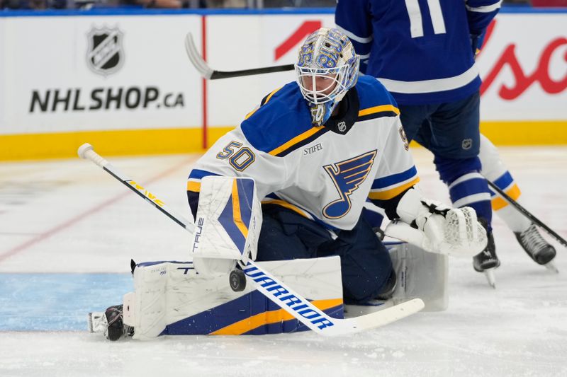 Oct 24, 2024; Toronto, Ontario, CAN; St. Louis Blues goaltender Jordan Binnington (50) makes a save against the Toronto Maple Leafs during the third period at Scotiabank Arena. Mandatory Credit: John E. Sokolowski-Imagn Images