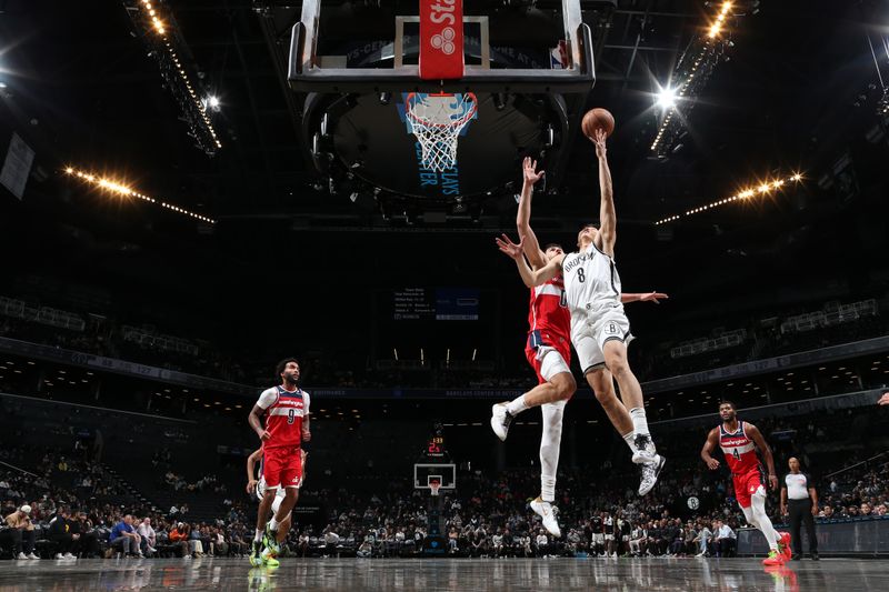 BROOKLYN, NY - OCTOBER 14: Cui Yongxi #8 of the Brooklyn Nets drives to the basket during the game against the Washington Wizards during a NBA preseason game on October 14, 2024 at Barclays Center in Brooklyn, New York. NOTE TO USER: User expressly acknowledges and agrees that, by downloading and or using this Photograph, user is consenting to the terms and conditions of the Getty Images License Agreement. Mandatory Copyright Notice: Copyright 2024 NBAE (Photo by Nathaniel S. Butler/NBAE via Getty Images)