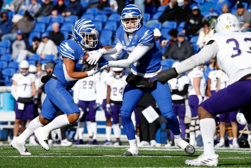 Nov 19, 2022; Memphis, Tennessee, USA; Memphis Tigers quarterback Seth Henigan (5) hands the ball off to Memphis Tigers running back Jevyon Ducker (8) during the first half against the North Alabama Lions at Simmons Bank Liberty Stadium. Mandatory Credit: Petre Thomas-USA TODAY Sports