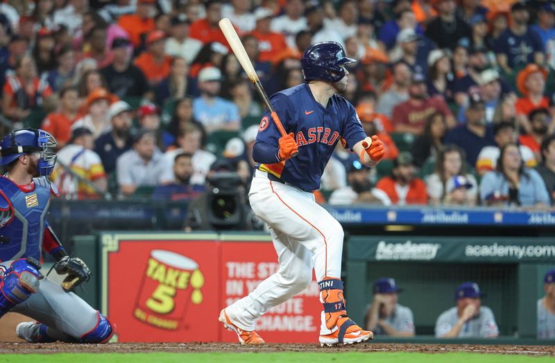Apr 14, 2024; Houston, Texas, USA; Houston Astros catcher Victor Caratini (17) hits an RBI double during the fourth inning against the Texas Rangers at Minute Maid Park. Mandatory Credit: Troy Taormina-USA TODAY Sports