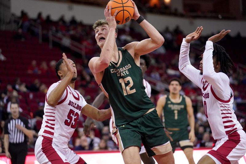 Feb 3, 2024; Fresno, California, USA; Colorado State Rams forward Patrick Cartier (12) holds onto the ball between Fresno State Bulldogs guard Xavier DuSell (53) and guard Donavan Yap Jr. (0) in the first half at the Save Mart Center. Mandatory Credit: Cary Edmondson-USA TODAY Sports