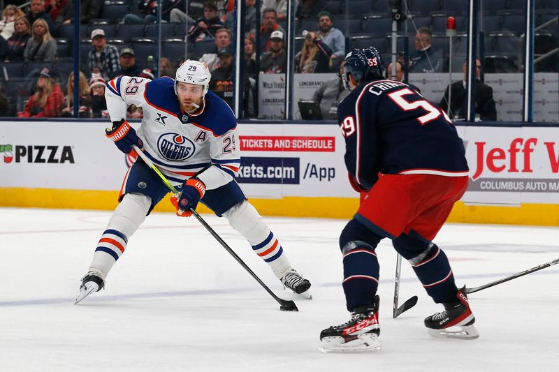 Oct 28, 2024; Columbus, Ohio, USA; Edmonton Oilers center Leon Draisaitl (29) looks to pass as Columbus Blue Jackets right wing Yegor Chinakhov (59) defends during the third period at Nationwide Arena. Mandatory Credit: Russell LaBounty-Imagn Images