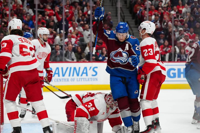 Mar 6, 2024; Denver, Colorado, USA; Colorado Avalanche center Nathan MacKinnon (29) celebrates an assist over Detroit Red Wings goaltender Alex Lyon (34) in the second period at Ball Arena. Mandatory Credit: Ron Chenoy-USA TODAY Sports