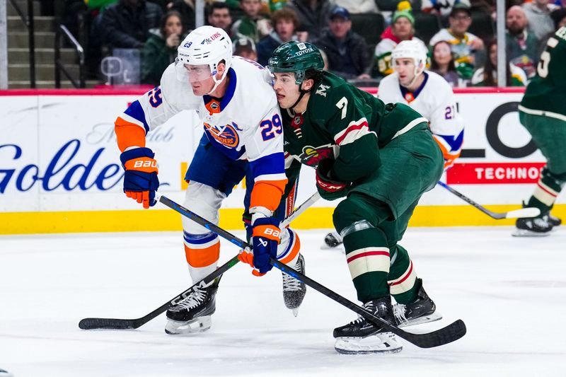 Jan 15, 2024; Saint Paul, Minnesota, USA; New York Islanders center Brock Nelson (29) is defended by Minnesota Wild defenseman Brock Faber (7) during the first period at Xcel Energy Center. Mandatory Credit: Brace Hemmelgarn-USA TODAY Sports