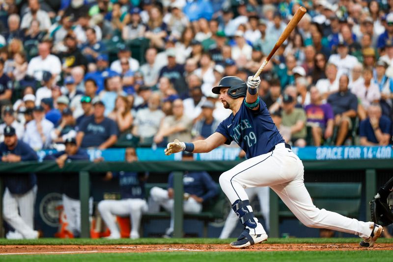 Aug 8, 2024; Seattle, Washington, USA; Seattle Mariners catcher Cal Raleigh (29) hits a single against the Detroit Tigers during the fourth inning at T-Mobile Park. Mandatory Credit: Joe Nicholson-USA TODAY Sports