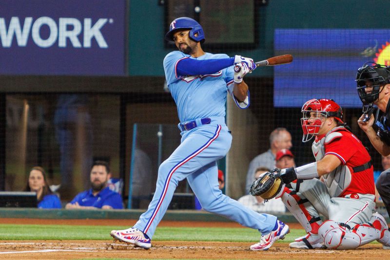 Apr 2, 2023; Arlington, Texas, USA; Texas Rangers second baseman Marcus Semien (2) hits a single during the first inning against the Philadelphia Phillies at Globe Life Field. Mandatory Credit: Andrew Dieb-USA TODAY Sports