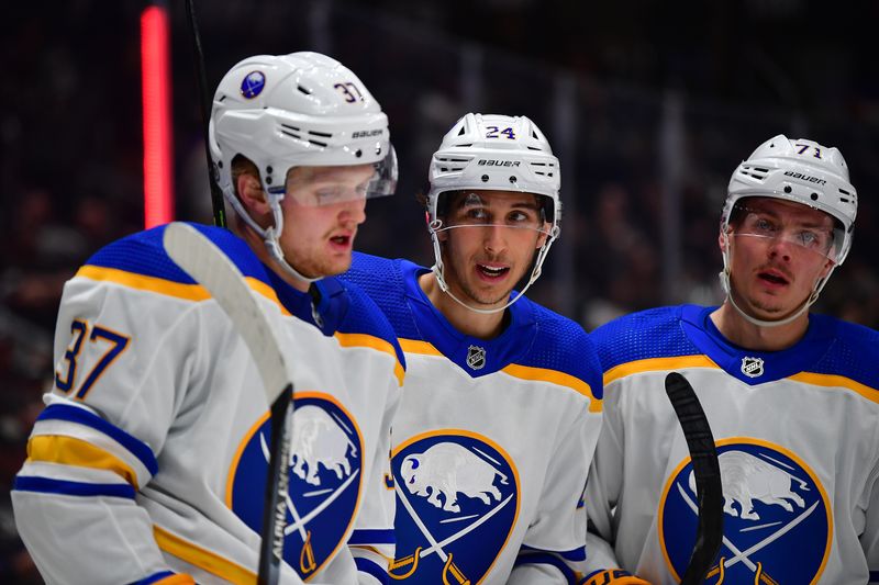 Feb 13, 2023; Los Angeles, California, USA; Buffalo Sabres center Dylan Cozens (24) celebrates his goal scored against the Los Angeles Kings with center Casey Mittelstadt (37) and left wing Victor Olofsson (71) during the third period at Crypto.com Arena. Mandatory Credit: Gary A. Vasquez-USA TODAY Sports