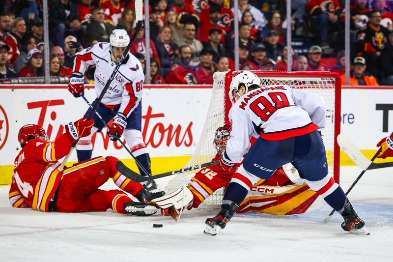 Jan 28, 2025; Calgary, Alberta, CAN; Calgary Flames goaltender Dustin Wolf (32) makes a save against Washington Capitals left wing Andrew Mangiapane (88) during the third period at Scotiabank Saddledome. Mandatory Credit: Sergei Belski-Imagn Images