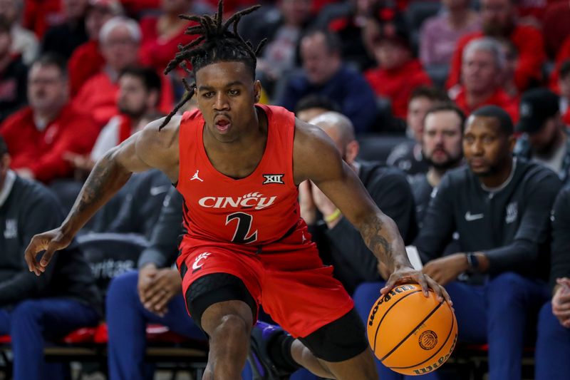 Mar 9, 2024; Cincinnati, Ohio, USA; Cincinnati Bearcats guard Jizzle James (2) dribbles against the West Virginia Mountaineers in the first half at Fifth Third Arena. Mandatory Credit: Katie Stratman-USA TODAY Sports