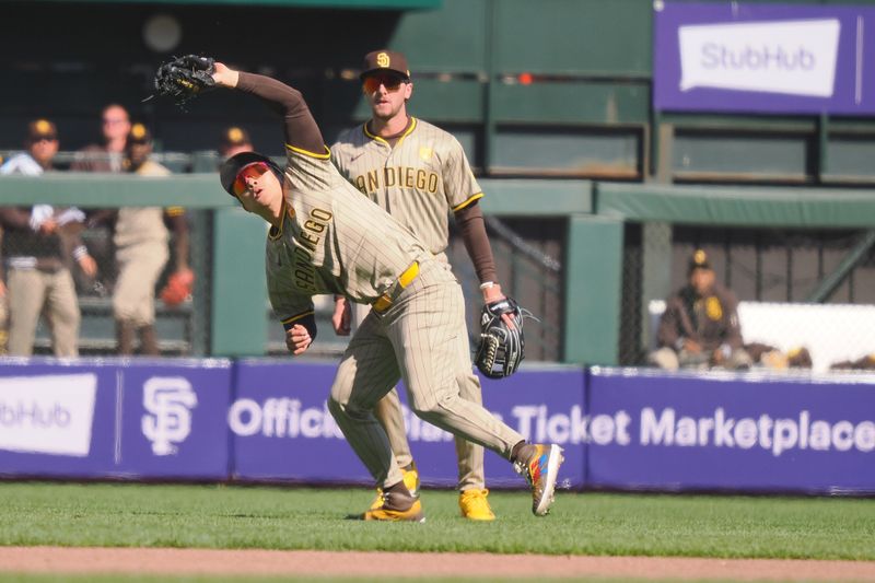 Apr 5, 2024; San Francisco, California, USA; San Diego Padres shortstop Ha-Seong Kim (7) catches the ball against the San Francisco Giants during the ninth inning at Oracle Park. Mandatory Credit: Kelley L Cox-USA TODAY Sports