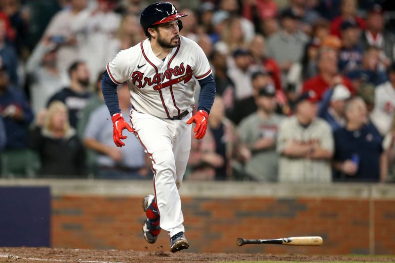 Oct 12, 2022; Atlanta, Georgia, USA; Atlanta Braves catcher Travis d'Arnaud (16) watches his RBI single against the Philadelphia Phillies in the sixth inning during game two of the NLDS for the 2022 MLB Playoffs at Truist Park. Mandatory Credit: Brett Davis-USA TODAY Sports