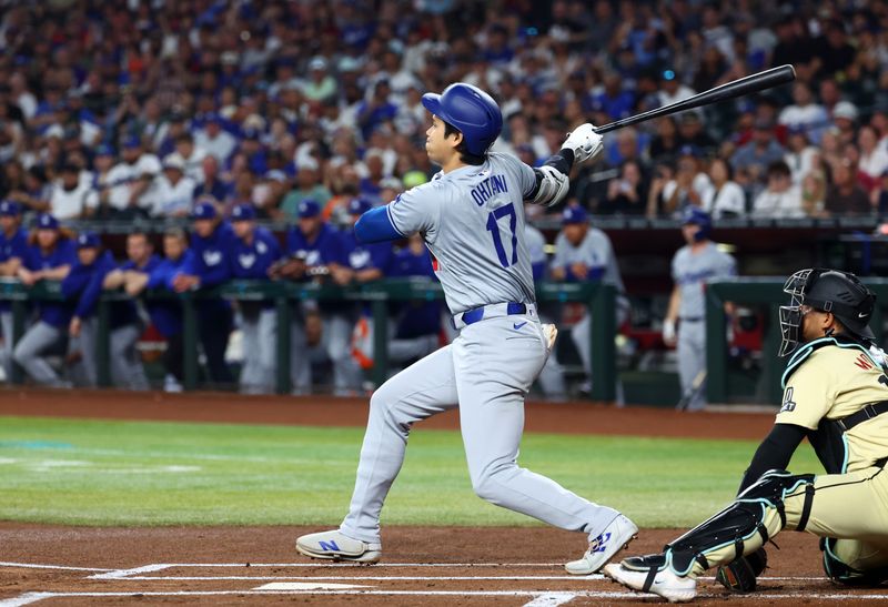 Apr 30, 2024; Phoenix, Arizona, USA; Los Angeles Dodgers designated hitter Shohei Ohtani hits a single in the first inning against the Arizona Diamondbacks at Chase Field. Mandatory Credit: Mark J. Rebilas-USA TODAY Sports