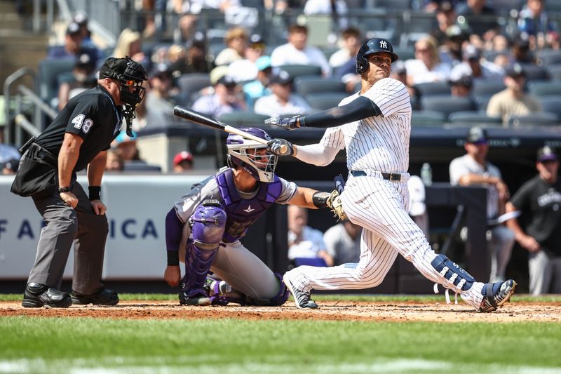 Aug 25, 2024; Bronx, New York, USA;  New York Yankees right fielder Juan Soto (22) hits an RBI single in the second inning against the Colorado Rockies at Yankee Stadium. Mandatory Credit: Wendell Cruz-USA TODAY Sports