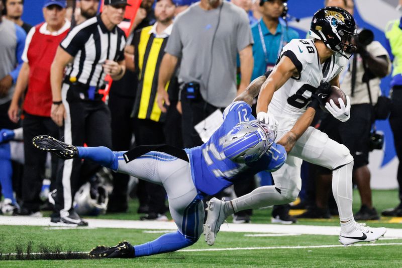 Detroit Lions cornerback Chase Lucas (27) attempts a tackle on Jacksonville Jaguars wide receiver Oliver Martin (88) during the second half of a preseason NFL football game, Saturday, Aug. 19, 2023, in Detroit. (AP Photo/Duane Burleson)