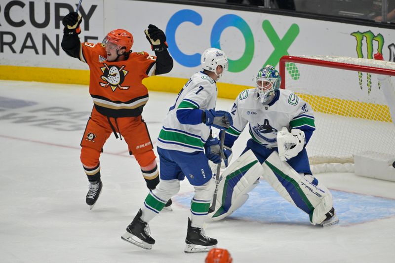 Nov 5, 2024; Anaheim, California, USA; Vancouver Canucks defenseman Carson Soucy (7) and goaltender Kevin Lankinen (32) look on as Anaheim Ducks center Mason McTavish (23) celebrates after a goal in the first period at Honda Center. Mandatory Credit: Jayne Kamin-Oncea-Imagn Images