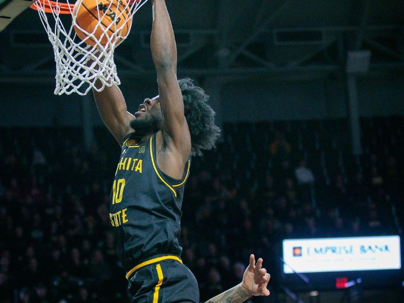 Feb 11, 2024; Wichita, Kansas, USA; Wichita State Shockers forward Dalen Ridgnal (10) dunks over Florida Atlantic Owls guard Alijah Martin (15) during the first half at Charles Koch Arena. Mandatory Credit: William Purnell-USA TODAY Sports