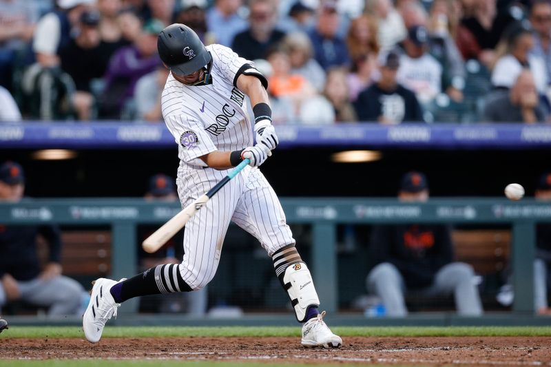 Jun 30, 2023; Denver, Colorado, USA; Colorado Rockies shortstop Ezequiel Tovar (14) hits a three run home run in the sixth inning against the Detroit Tigers at Coors Field. Mandatory Credit: Isaiah J. Downing-USA TODAY Sports