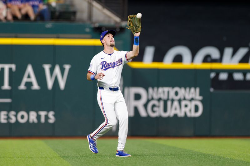 May 1, 2024; Arlington, Texas, USA; Texas Rangers outfielder Evan Carter (32) makes a catch during the first inning against the Washington Nationals at Globe Life Field. Mandatory Credit: Andrew Dieb-USA TODAY Sports