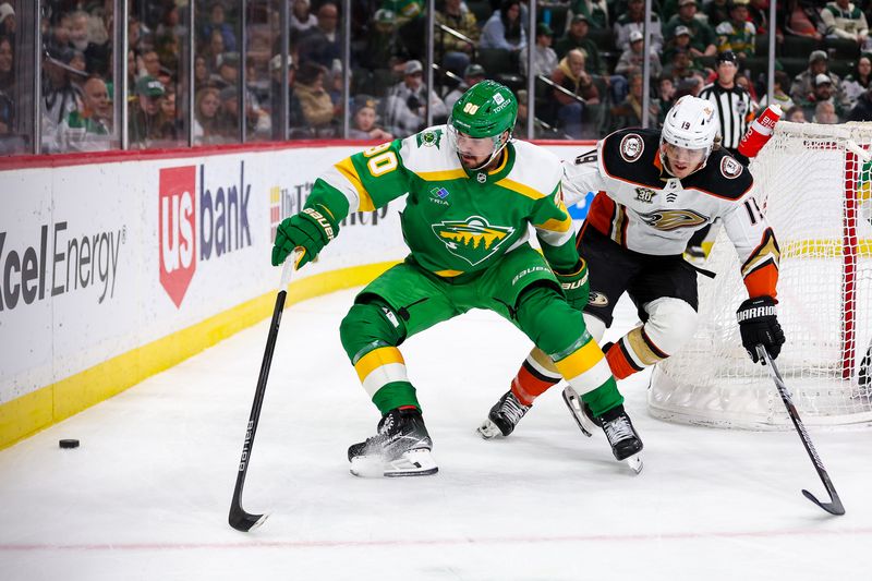 Jan 27, 2024; Saint Paul, Minnesota, USA; Minnesota Wild left wing Marcus Johansson (90) and Anaheim Ducks right wing Troy Terry (19) compete for the puck during the third period at Xcel Energy Center. Mandatory Credit: Matt Krohn-USA TODAY Sports