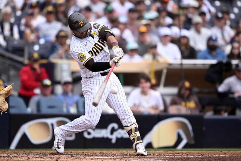 May 15, 2024; San Diego, California, USA; San Diego Padres third baseman Donovan Solano (39) hits a single against the Colorado Rockies during the seventh inning at Petco Park. Mandatory Credit: Orlando Ramirez-USA TODAY Sports