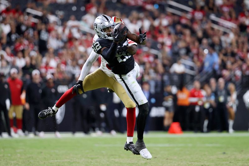 Las Vegas Raiders wide receiver Ramel Keyton (82) makes a catch over San Francisco 49ers cornerback Samuel Womack III (0) during the second half of an NFL preseason football game, Friday, Aug. 23, 2024, in Las Vegas. (AP Photo/Ian Maule)