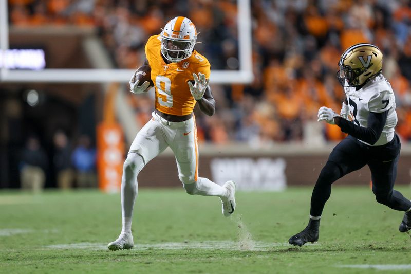 Nov 25, 2023; Knoxville, Tennessee, USA; Tennessee Volunteers wide receiver Ramel Keyton (9) runs the ball against Vanderbilt Commodores safety Marlen Sewell (7) during the second half at Neyland Stadium. Mandatory Credit: Randy Sartin-USA TODAY Sports