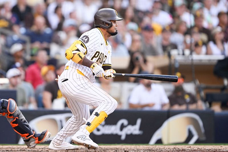 Sep 2, 2024; San Diego, California, USA; San Diego Padres first baseman Luis Arraez (4) hits a RBI single during the eighth inning against the Detroit Tigers at Petco Park. Mandatory Credit: Denis Poroy-USA TODAY Sports