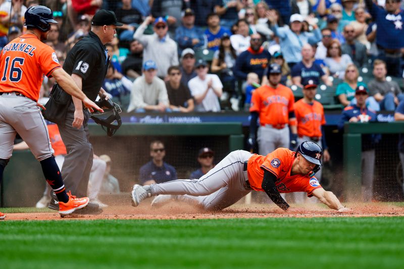 Jul 20, 2025; Seattle, Washington, USA; Houston Astros third baseman Shay Whitcomb (10) slides home to score a run against the Seattle Mariners during the fifth inning at T-Mobile Park. Mandatory Credit: Joe Nicholson-Imagn Images