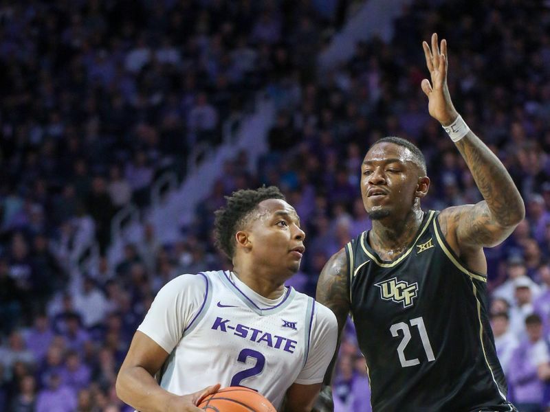 Jan 6, 2024; Manhattan, Kansas, USA; Kansas State Wildcats guard Tylor Perry (2) dribbles against UCF Knights guard C.J. Walker (21) during the first half at Bramlage Coliseum. Mandatory Credit: Scott Sewell-USA TODAY Sports